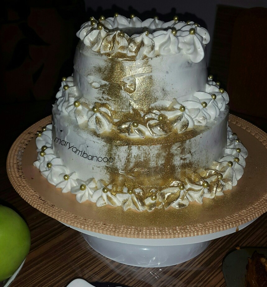 عکس کیک دو طبقه با روکش خامه و گرد طلا
